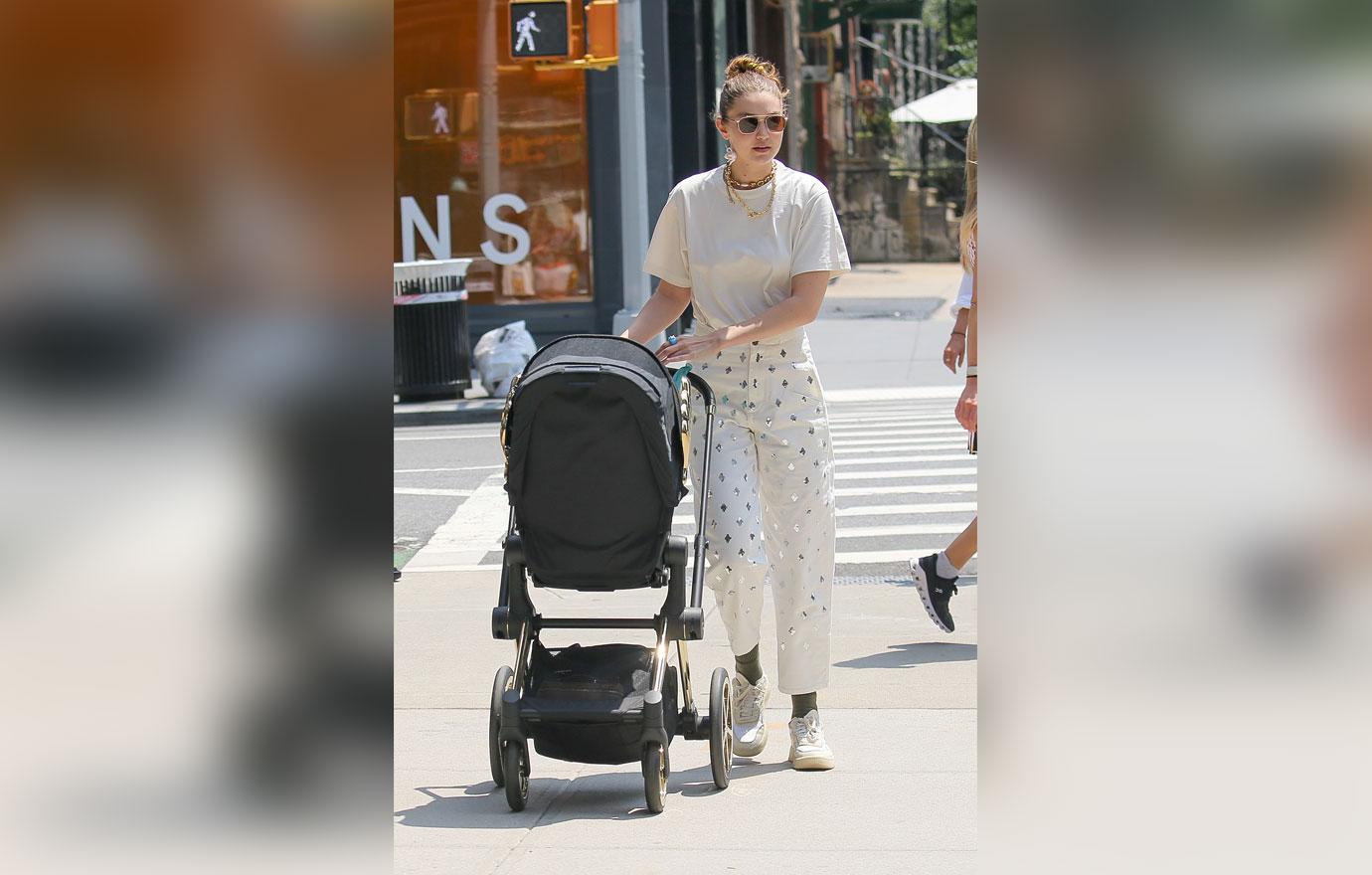 Gigi Hadid showcases her svelte abs in crop top as she pushes her daughter  Khai in her stroller