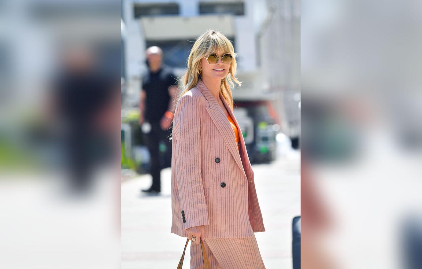 heidi klum poses in front of sports car outside of americas got talent