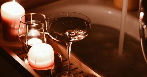 Photo of a running tub with candles.