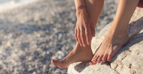 Photo of someone's feet and hands.