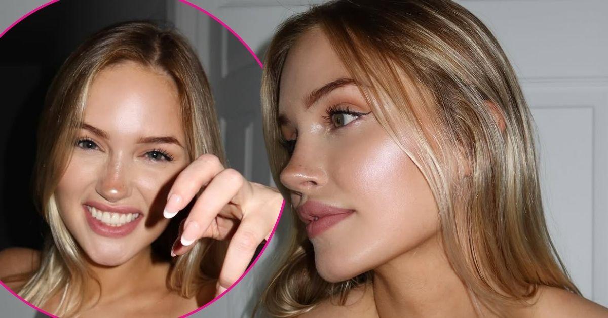 Tana Rain smiles brightly with her hand raised in a claw pose