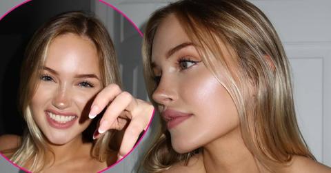 Tana Rain smiles brightly with her hand raised in a claw pose