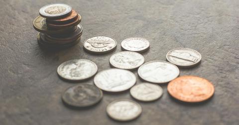 Assorted Silver-and-gold-colored Coins on Gray Surface