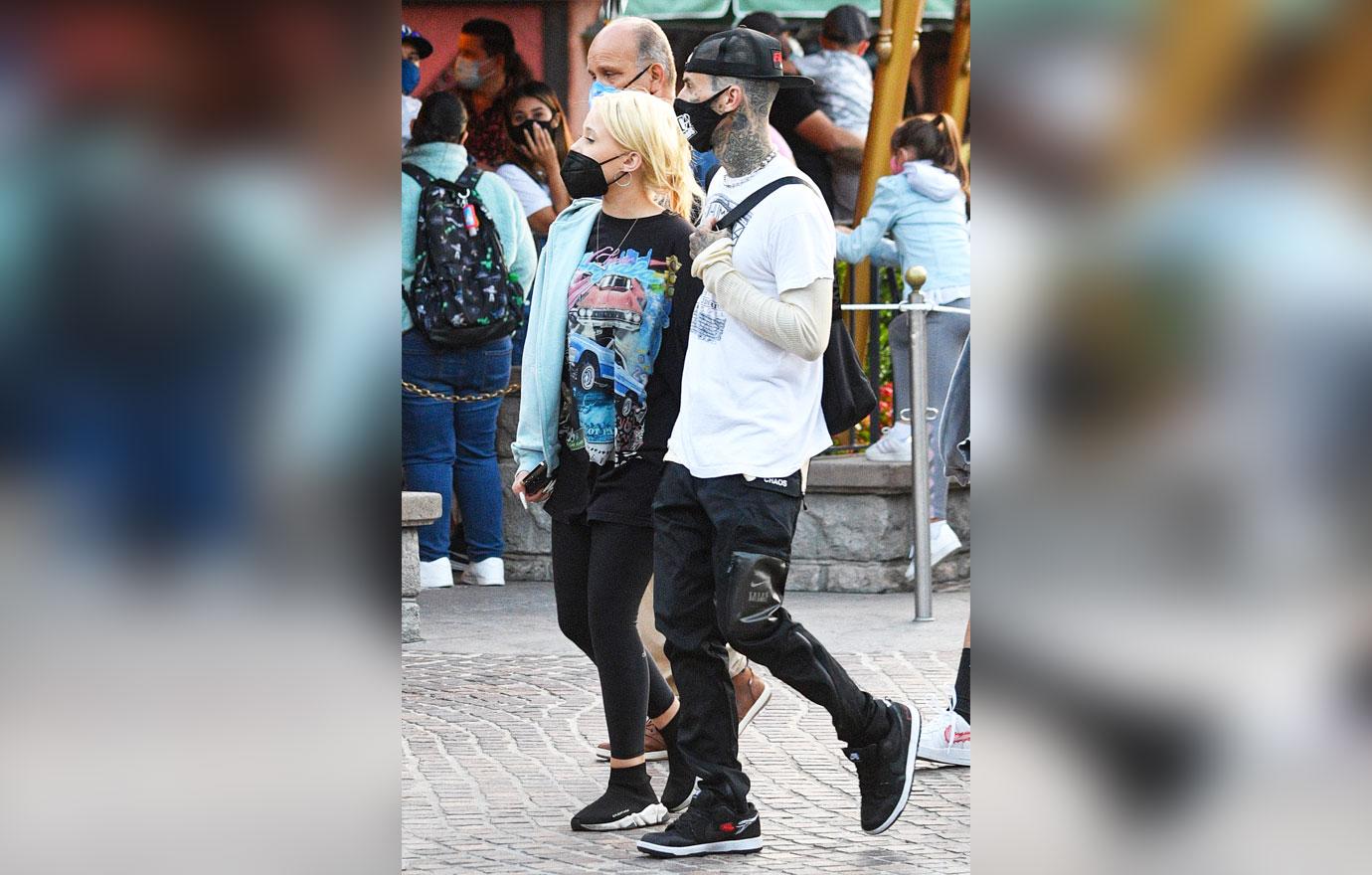 kourtney kardashian and travis barker take their modern family on a fun day out at disneyland