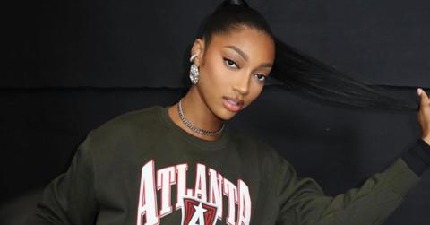 Angel Reese posing in her Atlanta Dream sweatshirt