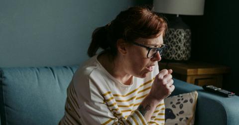 Photo of someone coughing.