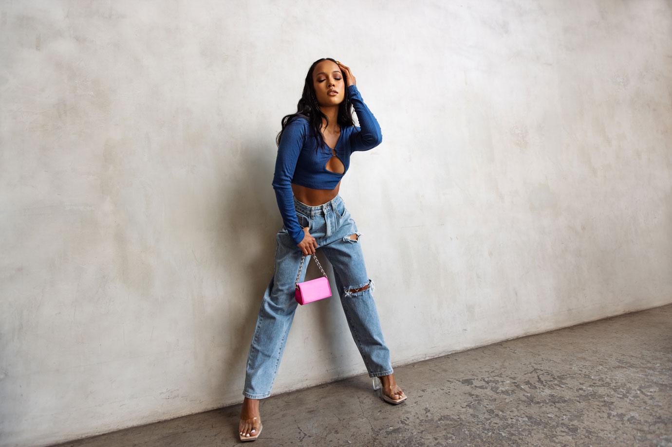 Karrueche Tran spills out of tiny denim bra-top while attending