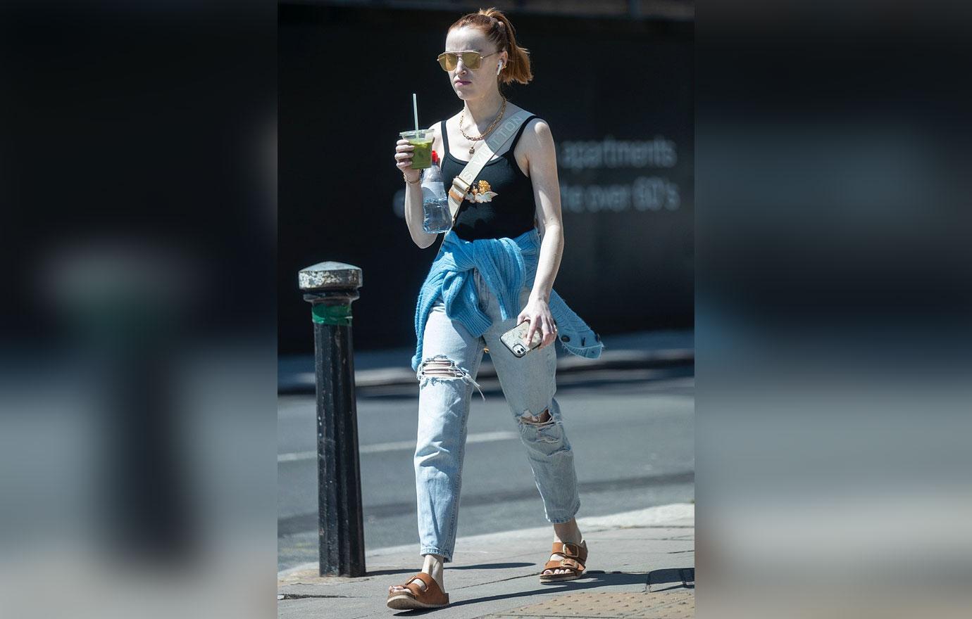 phoebe dynevor seen going for a walk on a sunny day in london wearing a crop top and jeans