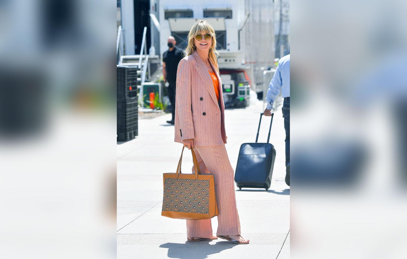 heidi klum poses in front of sports car outside of americas got talent