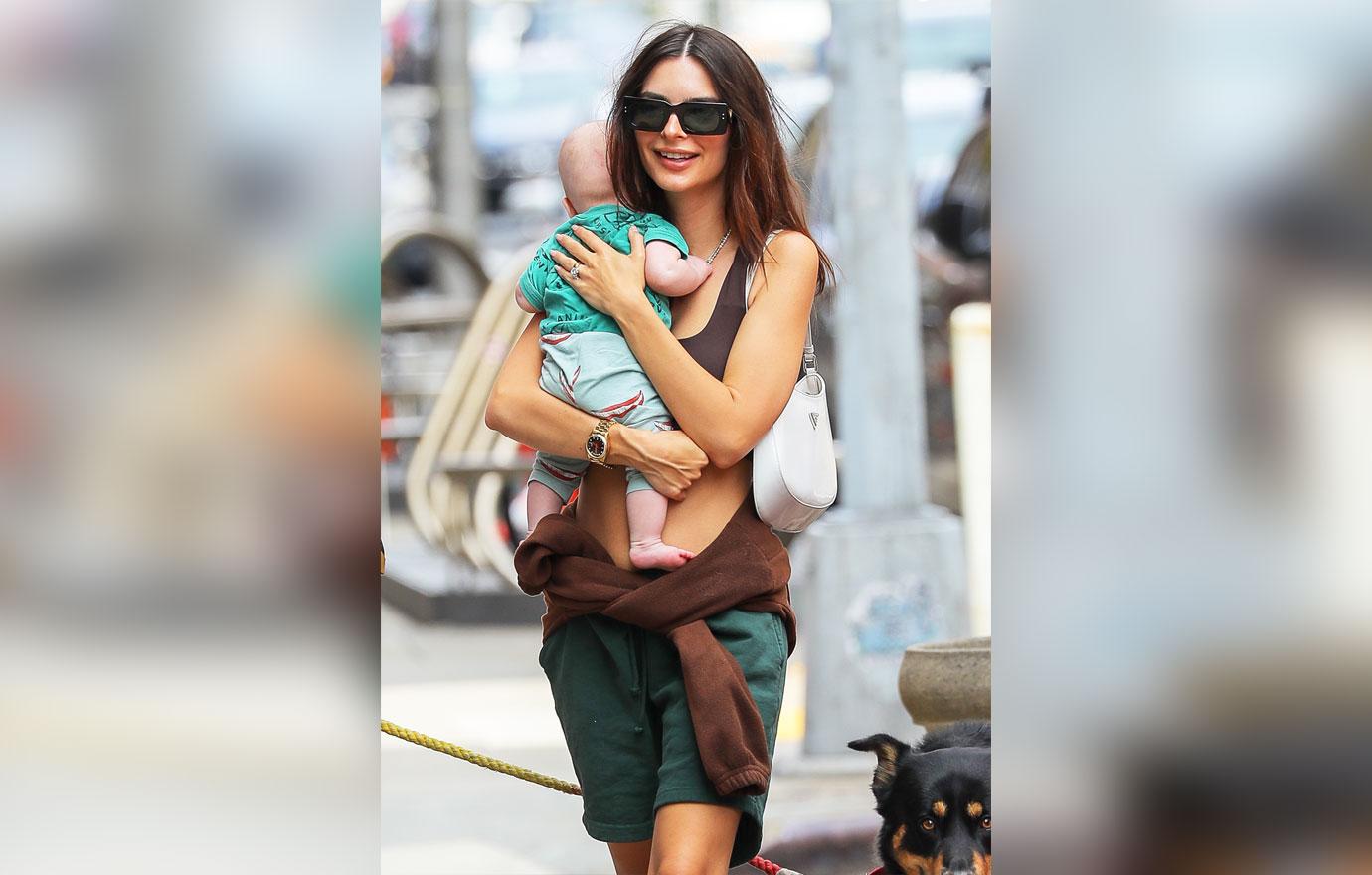 emily ratajkowski is all smiling while carrying her baby as they taking a stroll with husband sebastian bear mcclard in nyc