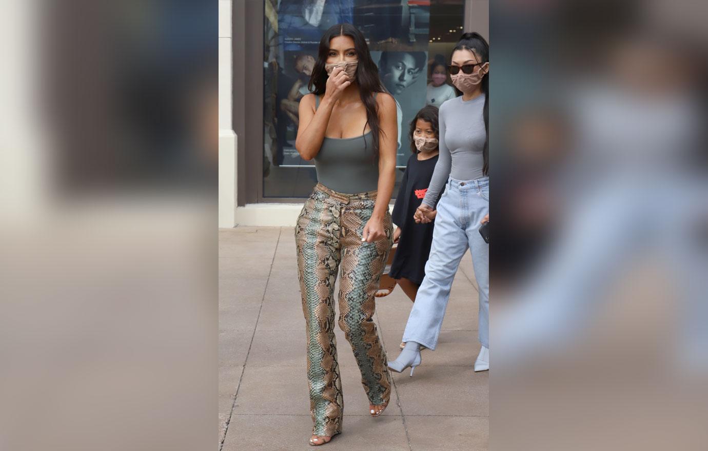 Kim Kardashian flaunts shrinking frame & tiny waist in crop top with  matching snake skin pants on her way to Skims shoot