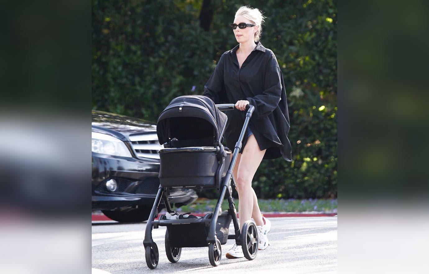 elsa hosk wears a black tuxedo shirt while on a stroll with her daughter