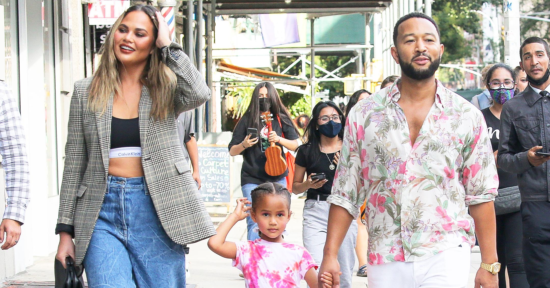 john legend and chrissy teigen enjoy a walk with their daughter in nyc