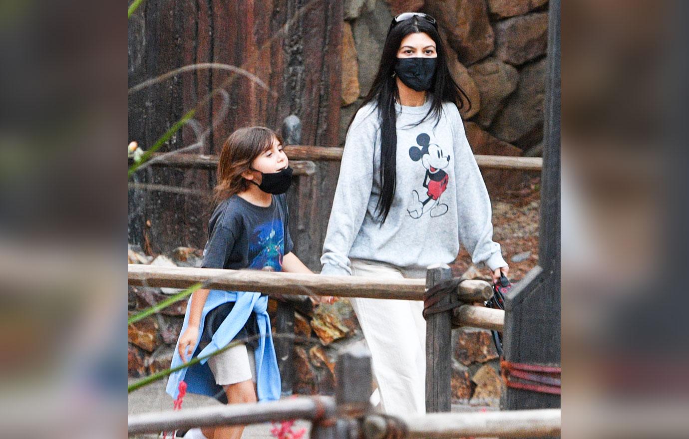 kourtney kardashian and travis barker take their modern family on a fun day out at disneyland