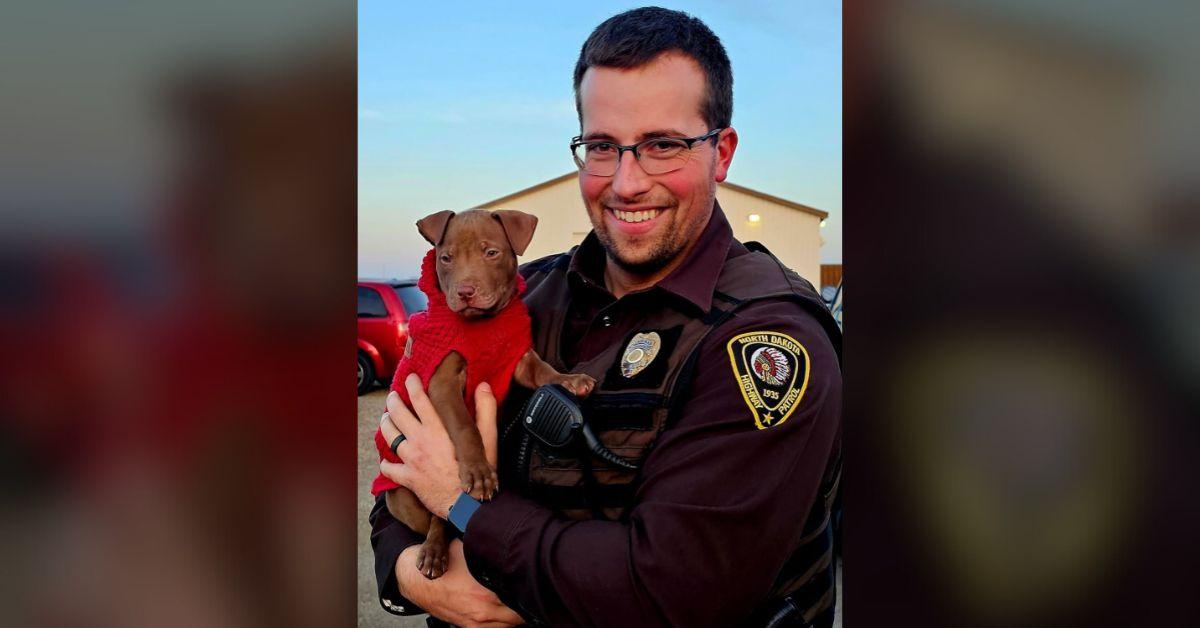 Image of Trooper Steenstrup sweetly posed with his new canine pal.
