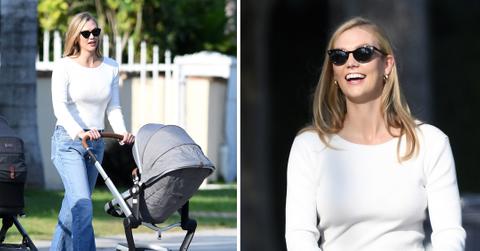 model karlie kloss smiles as she takes a walk with her baby and a friend