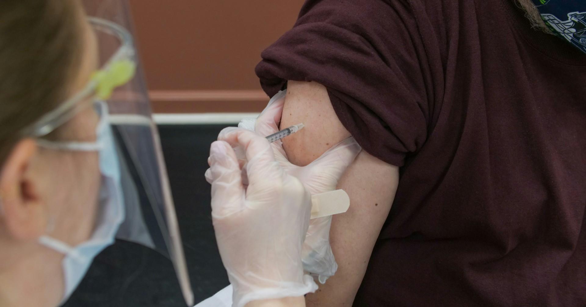 Photo of someone getting a shot. 