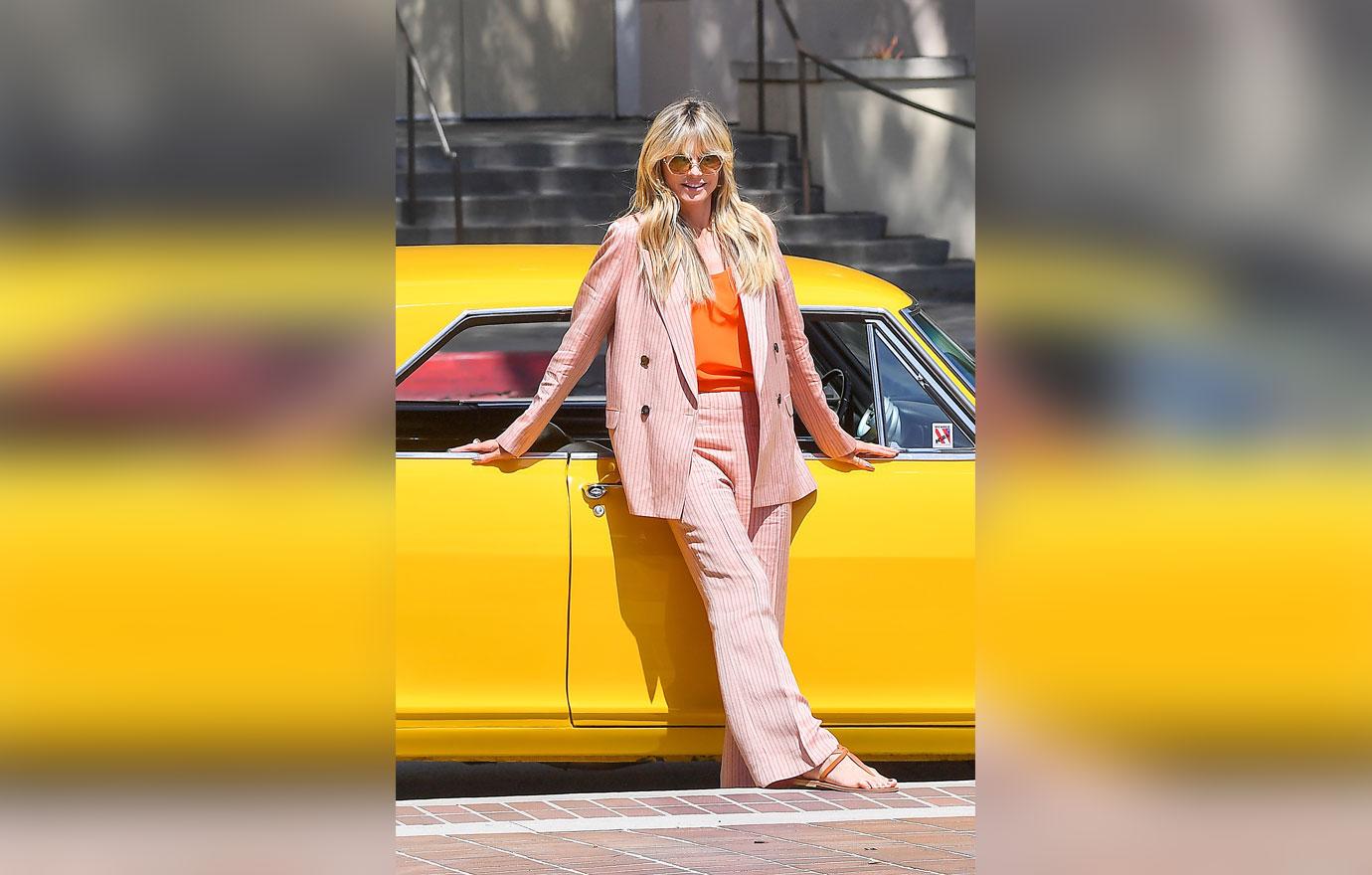 heidi klum poses in front of sports car outside of americas got talent