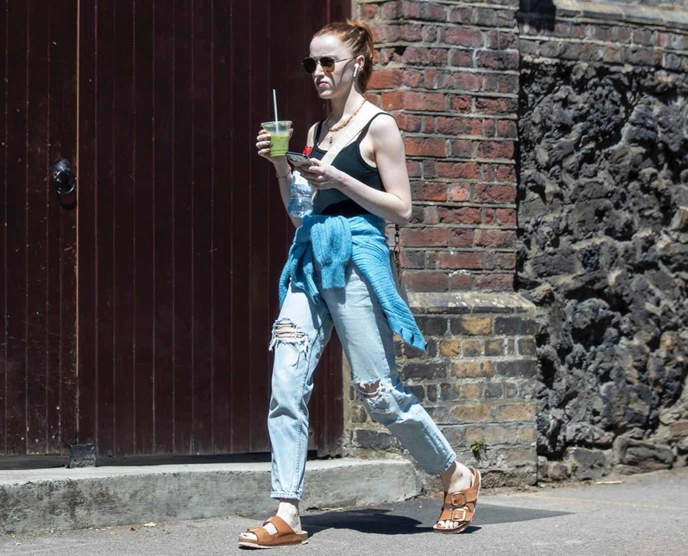 phoebe dynevor seen going for a walk on a sunny day in london wearing a crop top and jeans